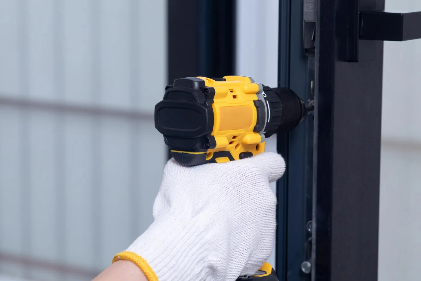 Perçage et remplacement d'une serrure sur une porte d'immeuble dans le Val-d'Oise